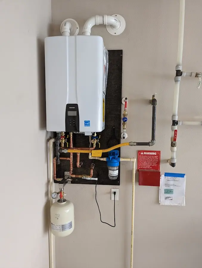 Professional plumber installing copper piping in a Oak Hills home